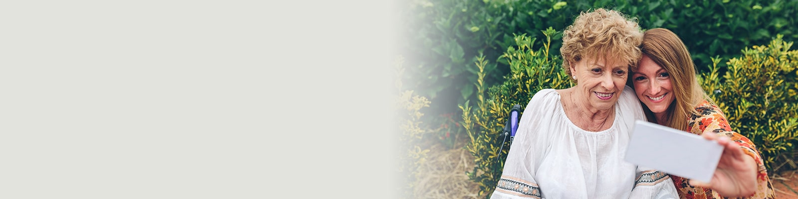 daughter taking a selfie with her mother at a care facility