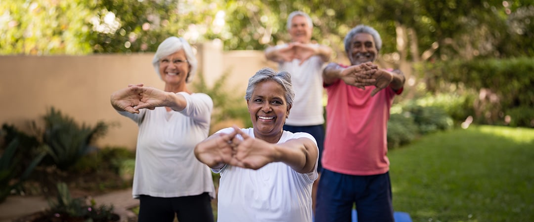 A group of elderly people exercising.